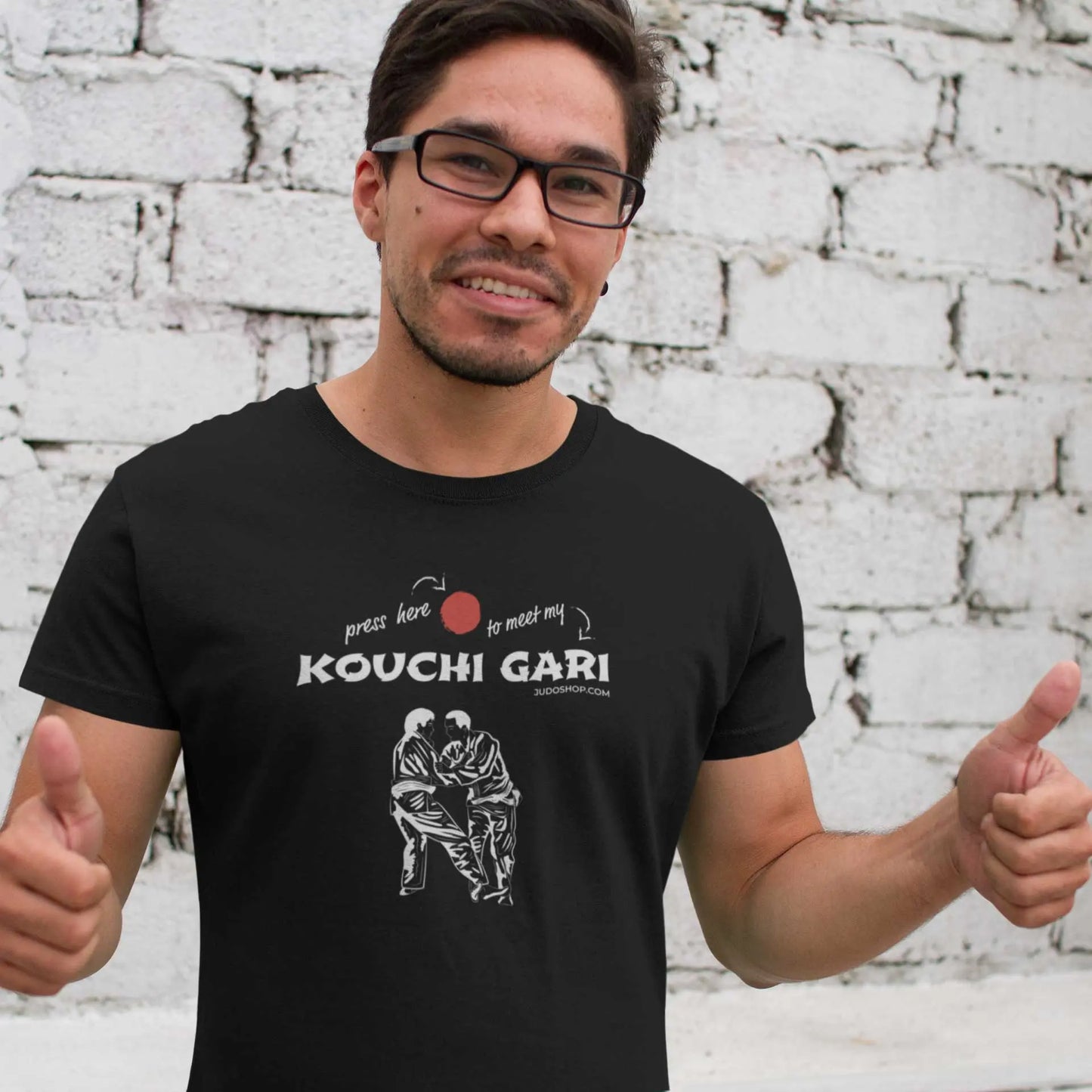 Man smiling and giving thumbs-up while wearing the Judo Kouchi Gari T-Shirt, ideal for casual and sporty occasions.