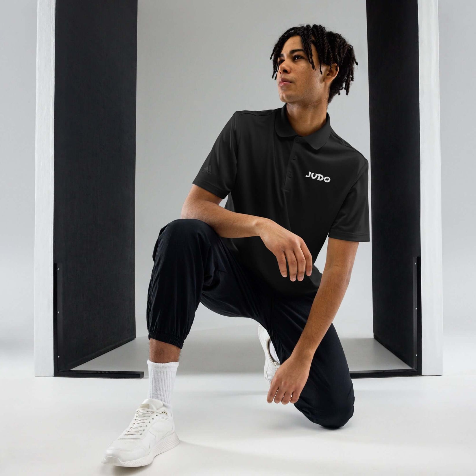 Adidas Judo Polo T-shirt front view showing minimalist JUDO text on black polo