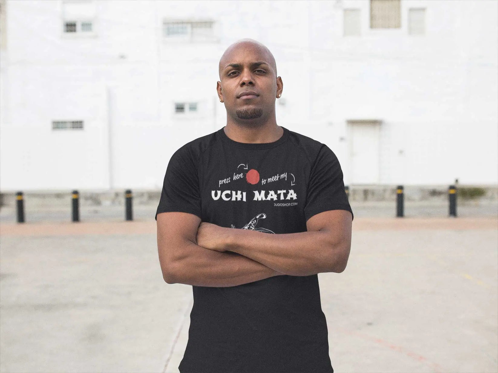 Man standing confidently in a black Judo T-Shirt with 'Press here to meet my Uchi Mata' design, perfect for martial arts enthusiasts.