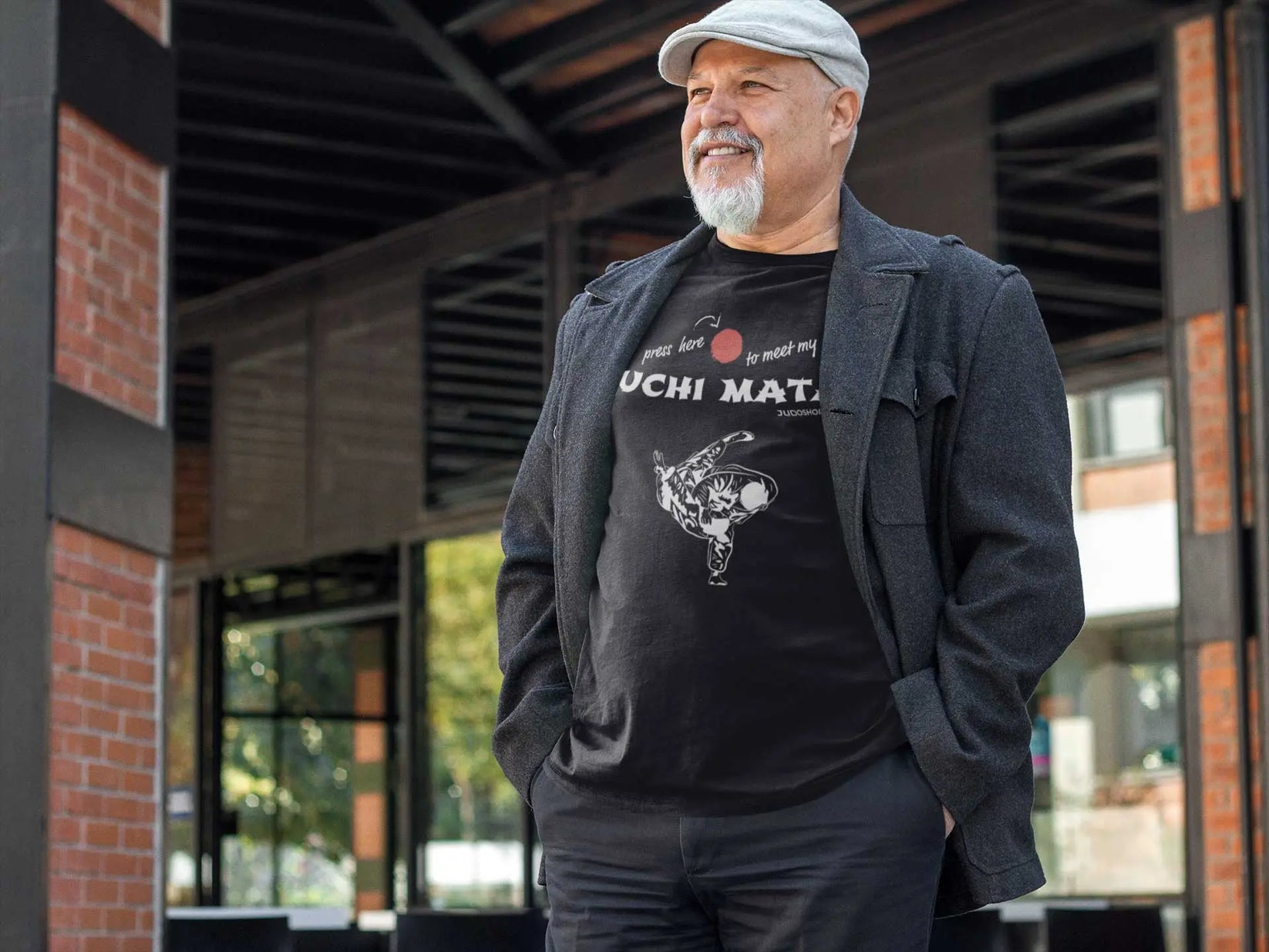 Man outdoors wearing a black Judo T-Shirt with 'Press here to meet my Uchi Mata' design, ideal for casual outings.